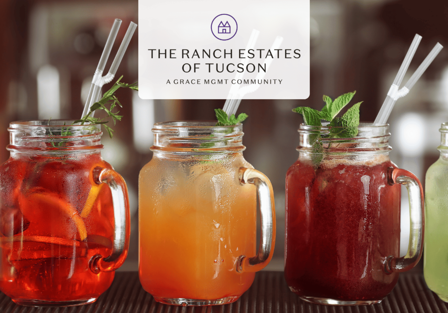 Three mason jar drinks with mint and citrus on a bar, logo reads The Ranch Estates of Tucson.